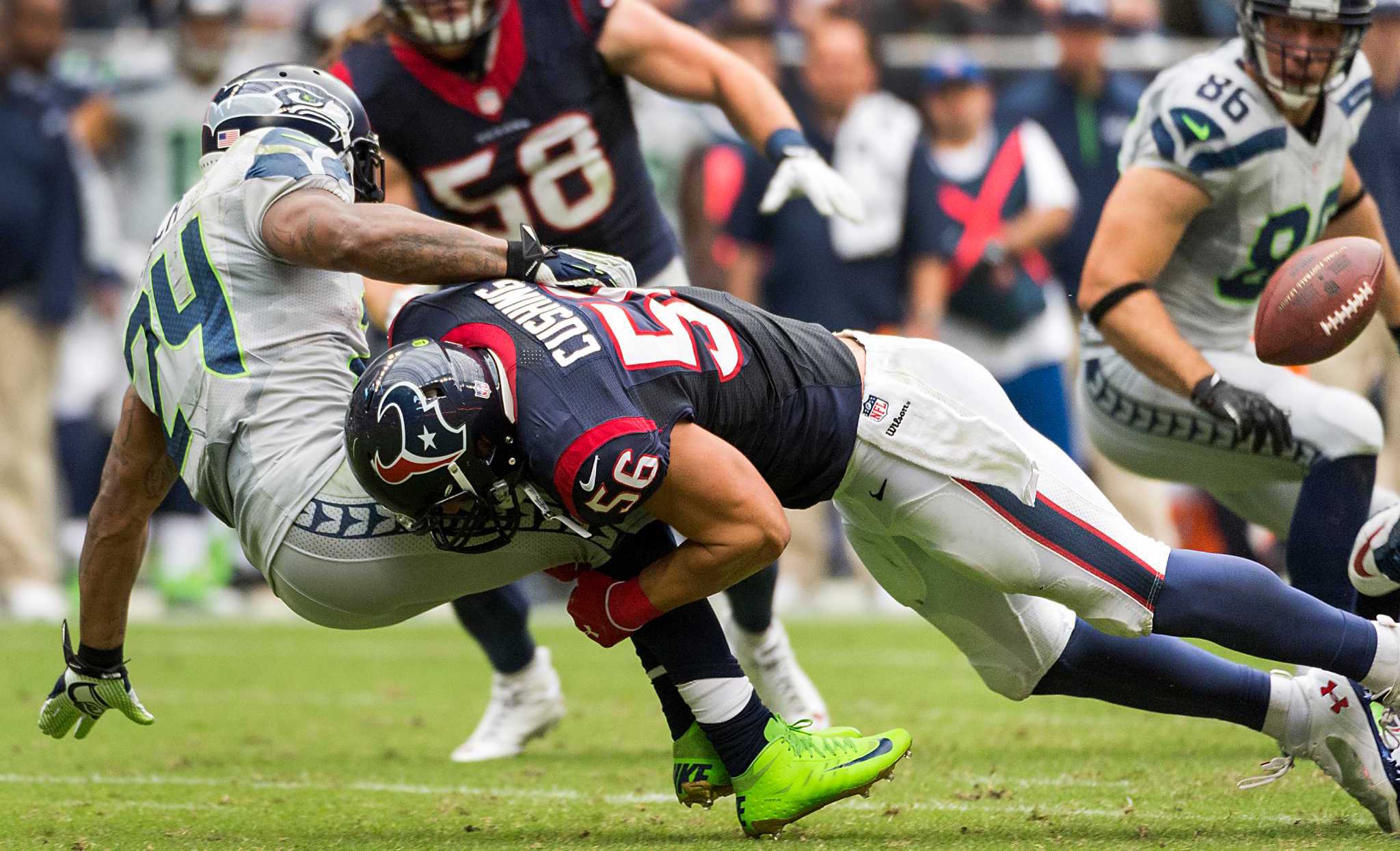 Seattle Seahawks running back Marshawn Lynch (24) fumbles as he is hit by Houston Texans inside linebacker Brian Cushing (56) during the first half of an NFL football game on Sunday, Sept. 29, 2013, in Houston. ( Smiley N. Pool / Houston Chronicle )